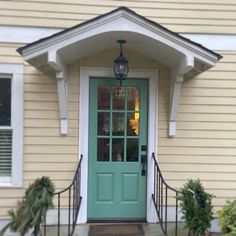 a green front door on a yellow house