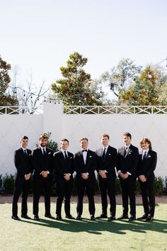 a group of men in suits standing next to each other