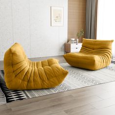 two yellow chairs sitting on top of a wooden floor