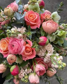 a bouquet of pink roses and other flowers