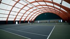 an indoor tennis court is shown in this image