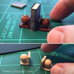 two pictures of small wooden toys on top of a green table and one is holding a book