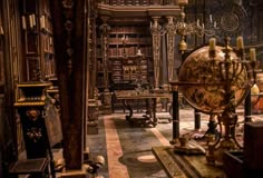 an old library filled with lots of books and antique furniture, including a large globe