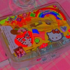 a plastic container filled with assorted stickers