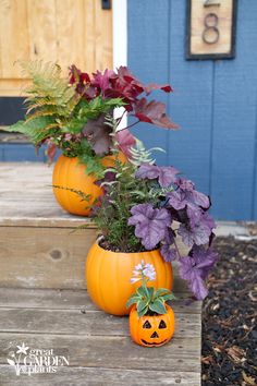 two pumpkin shaped planters sitting on top of a wooden porch next to purple flowers