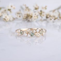 a close up of a ring with flowers in the background