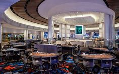 the inside of a casino with tables and chairs