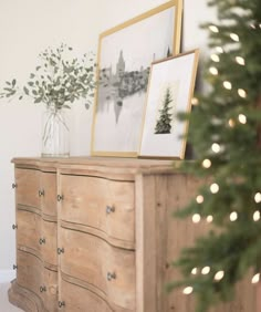 a christmas tree is sitting on top of a dresser