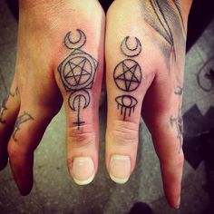 two hand tattoos with symbols on them