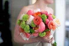 a woman holding a bouquet of flowers in her hands