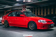 a red car parked in a parking garage