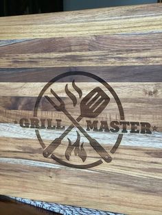 the grill master logo is engraved on a cutting board that's made out of wood