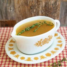 a white bowl filled with soup on top of a plate