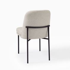 an upholstered chair with a black frame and arm rests against a white background