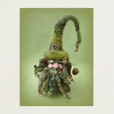 a green gnome's hat hanging on a wall