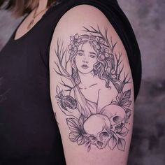 a woman with flowers and skulls on her arm