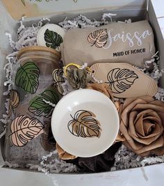 an open box with flowers, cookies and napkins in it that says sussa maid of honor