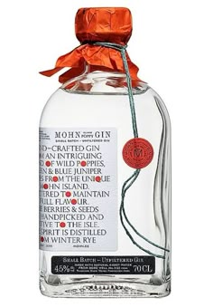 a bottle of gin with an orange ribbon around it's neck and label on the front