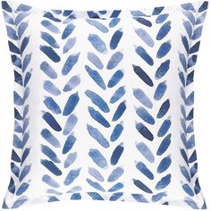 a blue and white pillow with watercolor paint strokes on the front, along with two pillows