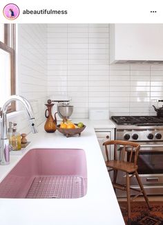 a kitchen with a sink, stove and counter top