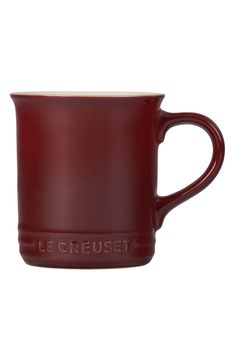 a red mug with the word le creuset on it