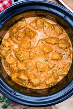 a crock pot filled with food sitting on top of a table