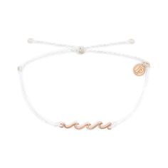 PRICES MAY VARY. DAINTY WAVE CHARM - Embellished with a rose gold-plated wave charm that accentuates the braided band, this accessory offers a minimalist yet elegant addition to your everyday outfit. WATERPROOF BRACELET - This Delicate Wave Bracelet from Pura Vida is 100% waterproof. Go conquer the waters without worrying about your accessory. This premium bracelet will not fade nor disintegrate even when in contact with water. ADJUSTABLE BRAIDED BAND - This bracelet comes with an adjustable ban Wave Bracelet, Rose Gold Charms, Gold Waves, Pura Vida Bracelets, Hang Ten, Brass Charms, Bar Bracelets, Gold Charm, Delicate Bracelet