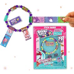 a hand holding a beaded bracelet with stickers on it and an ad for the store