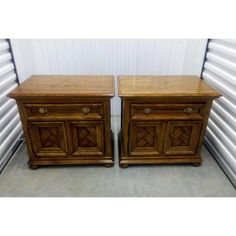 two wooden cabinets sitting next to each other