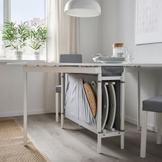 a dining room table with chairs and a basket under it