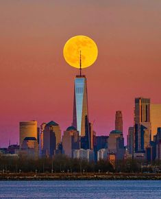 the full moon is setting over new york city