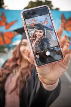 a woman is holding up her cell phone