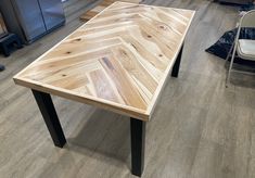 a wooden table sitting on top of a hard wood floor