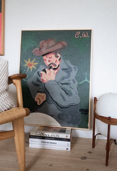 a painting is on the wall next to a chair