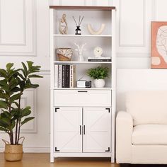 a living room with a white bookcase next to a couch and potted plant