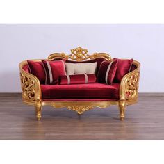 a red and gold couch sitting on top of a hard wood floor