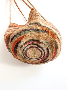 Agave fiber, tightly woven basket purse in faded pastels (likely vegetable dyed). Great as a hanging planter, use as an organizer, or as a farmers market gathering vessel. Handmade vintage. Shigra bag from Equador or Guatemala. 9" high with 9" round bottom Handle drop 27" Condition: Great vintage, cannot tolerate too much weight as the straps could weaken due to age. Could be reinforced at a later time or after heavy use. Colorful Baskets, Rope Bag, Market Tote, Basket Bag, Hanging Planters, Basket Weaving, Crochet Bag, Straw Bag, Pouch