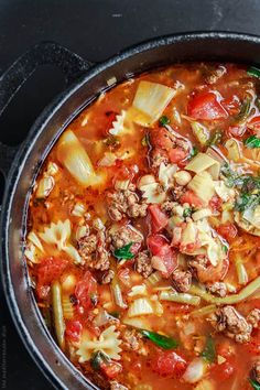 a pot filled with pasta, meat and vegetables