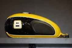 a yellow and black speaker sitting on top of a shelf