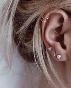 an ear with two piercings on top of it and the words, i love you to