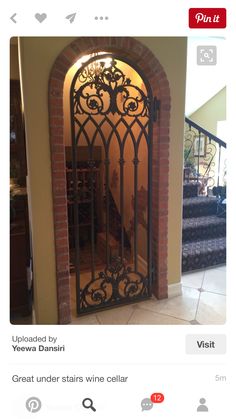 an iron gate in the middle of a room with stairs and steps leading up to it