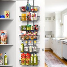 an organized pantry with hanging baskets and food on the wall next to shelves filled with condiments