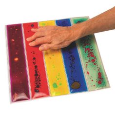 a person's hand holding onto a multicolored piece of paper