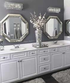 a bathroom with two sinks and three mirrors on the wall next to eachother