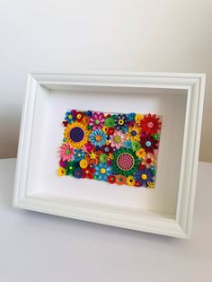 a white frame with colorful flowers in it