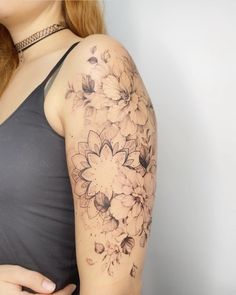 a woman with a flower tattoo on her arm