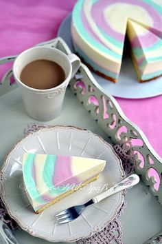 a slice of cake on a plate next to a cup of coffee