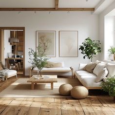 a living room filled with lots of furniture and plants on top of wooden flooring