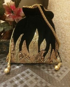 a black velvet purse with gold embellishments