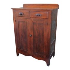 an old wooden cabinet with two doors on the front and one door open to reveal a drawer